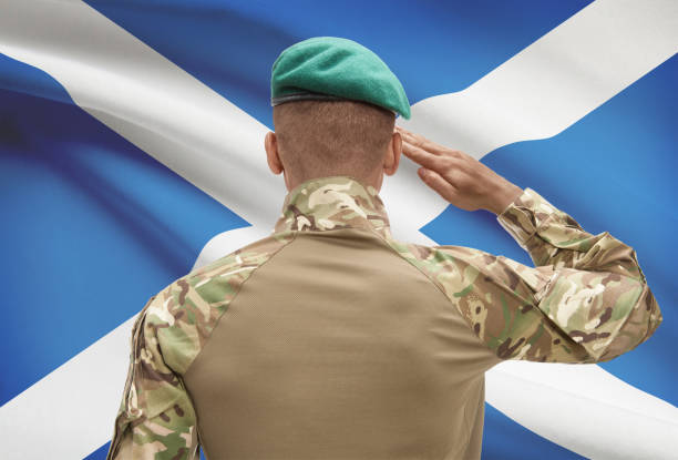 istock Dark-skinned soldier with flag on background - Scotland 688540328