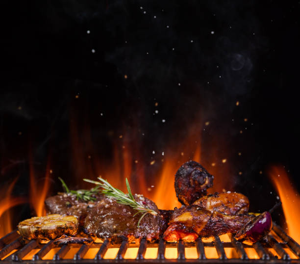 istock Beef steaks on the grill grate, flames on background 688548518