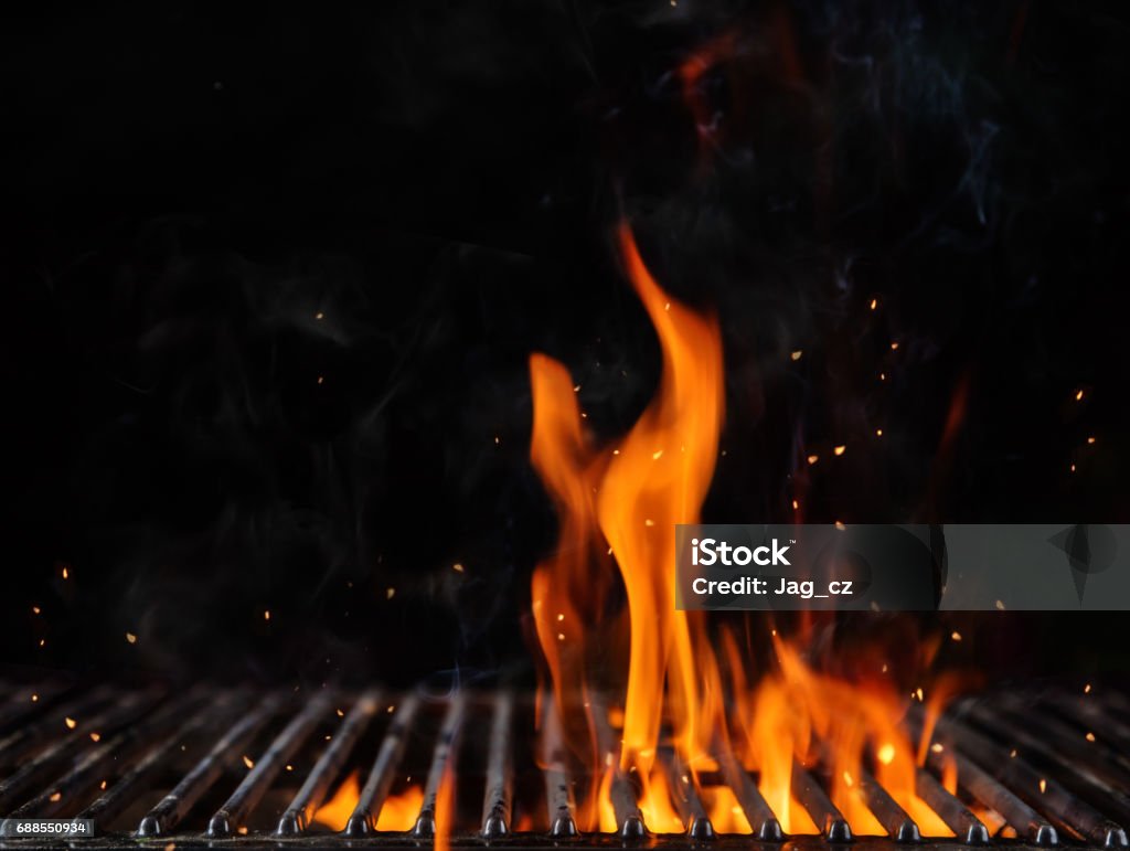 Empty flaming charcoal grill with open fire Empty flaming charcoal grill with open fire, ready for product placement. Concept of summer grilling, barbecue, bbq and party. Black copyspace Barbecue Grill Stock Photo