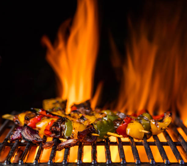 istock Skewer on the grill grate, flames on background 688551052