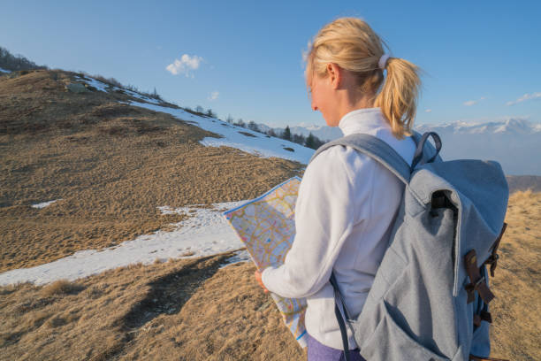 istock Hiker female looking at map on mountain trail 688553128
