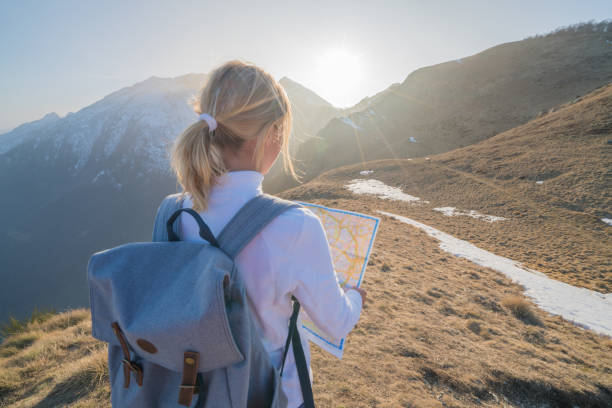 istock Hiker female looking at map on mountain trail 688553558