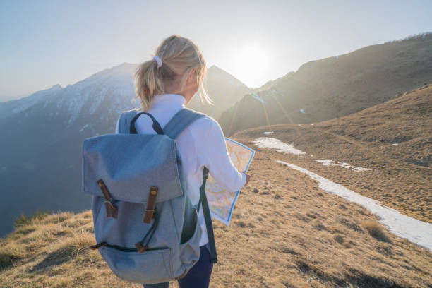 Hiker female looking at map for directions