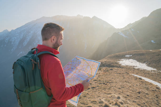 istock Hiker male looking for directions on mountain trail 688553984