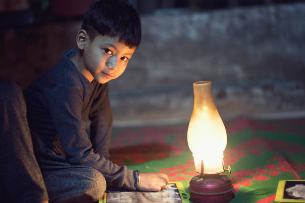 istock Boy studying in oil lamp 688554266