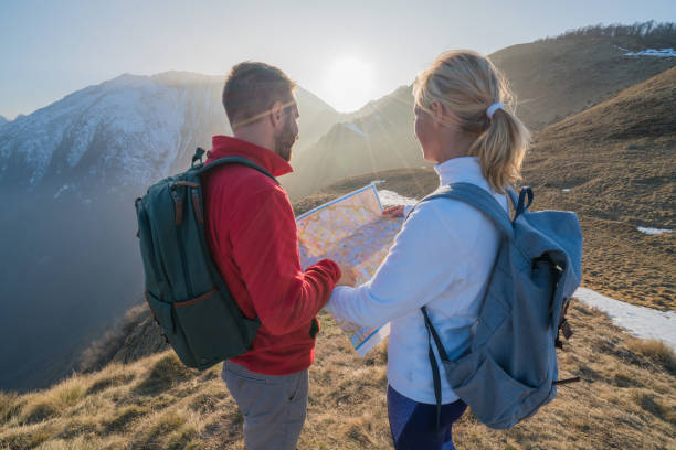 istock Two hikers on mountain trail looking at map 688554940