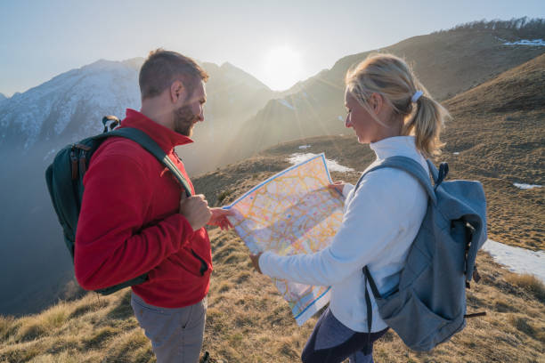 istock Teammates hiking in Switzerland looking at map 688555694