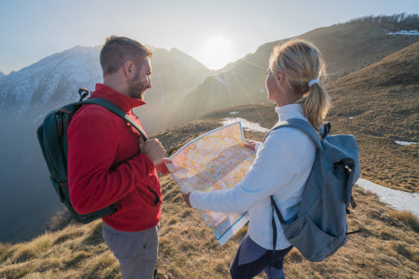 istock Teammates hiking in Switzerland looking at map 688555760
