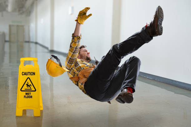 Worker Falling on Wet Floor Worker falling on wet floor inside building slippery stock pictures, royalty-free photos & images