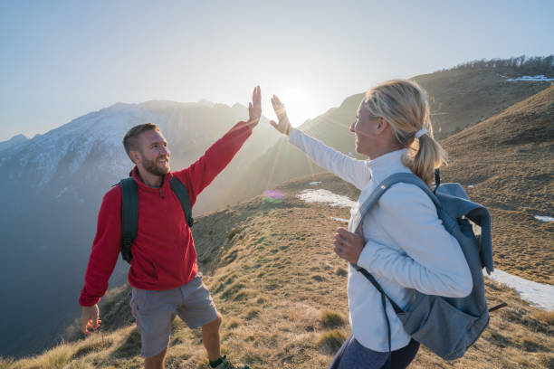 istock Two hikers celebrating on mountain top 688557302