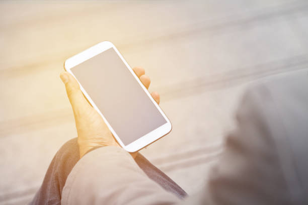 istock Businessman holding smart phone with empty screen 688559646
