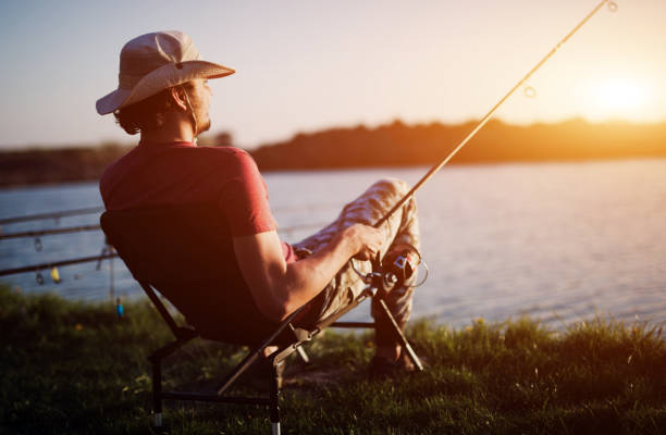 istock Men fishing in sunset and relaxing while enjoying hobby 688560266