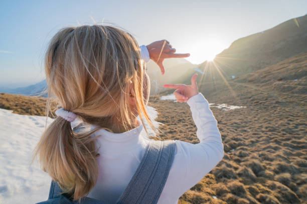 Hiker female framing nature with fingers