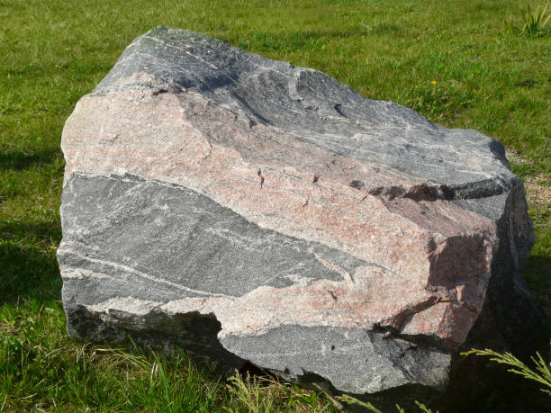 istock Rough Rock Solid Stones on Grass in a Park in Sunlight. 688566386