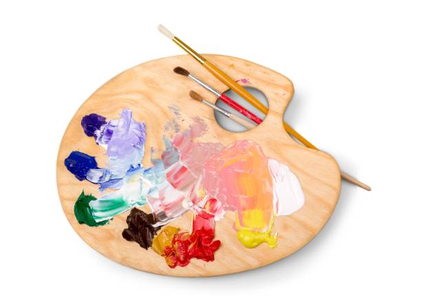 Artist. Wooden art palette with blobs of paint and a brushes on white background artist stock pictures, royalty-free photos & images