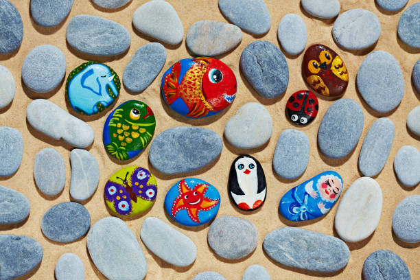 Rounded stones from sea vacation painted, souvenir made by kid stock photo