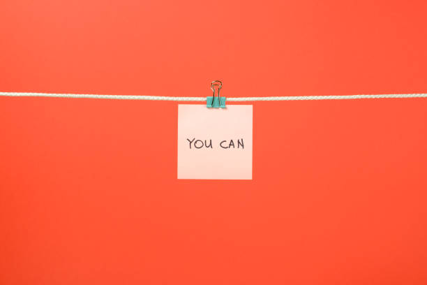 istock Pink paper sheet on the string with text 