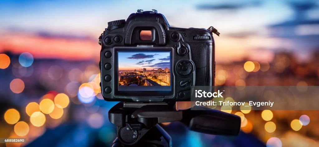 Digital camera Digital camera on the background of the evening city Home Video Camera Stock Photo