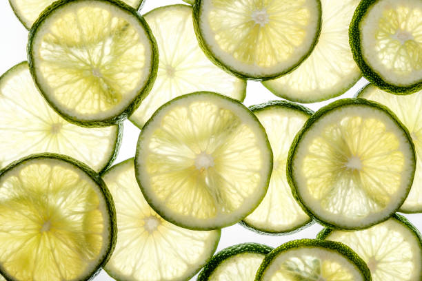 istock Bright citrus lime slices. Juicy transparent fruit on white 688589456