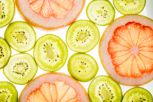 istock Bright sweet grapefruit and kiwi slices. Juicy transparent fruit on white 688589528