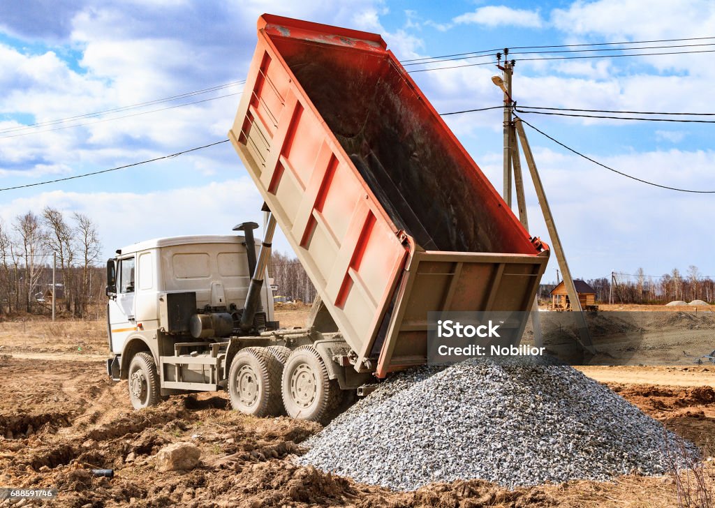 Dumptruck in action Dumptruck in action on a construction site Transportation Stock Photo