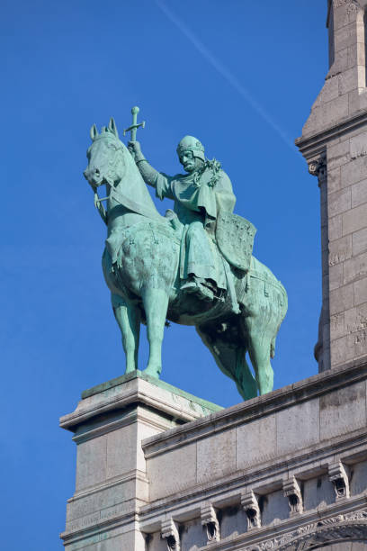 Equestrian bronze statue of Saint-Louis brandishing its sword and the crown of thorns on the terrace of the entrance porch to the three arches of the basilica of the Sacred Heart of Montmartre. The statue was made by Hippolyte Jules Lefèbvre in 1891.