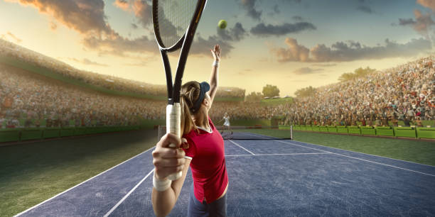 Tennis: Female sportsman in action Female sportsman is playing tennis on an outdoor stadium full of spectators. She is wearing unbranded sports cloth and using unbranded sport equipment baseline stock pictures, royalty-free photos & images