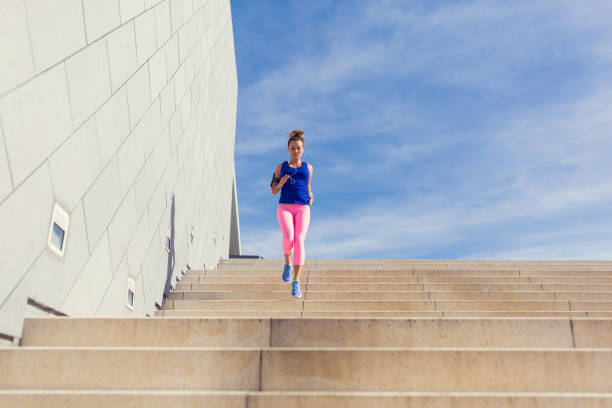 istock Sportswoman jogging downstairs 688595216