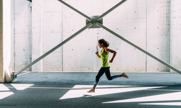 istock Sportswoman jogging outside 688595290