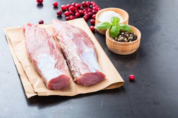 istock Raw pork tenderloin on craft pape 688595680