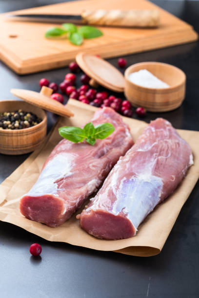 istock Raw pork tenderloin on craft pape 688595802
