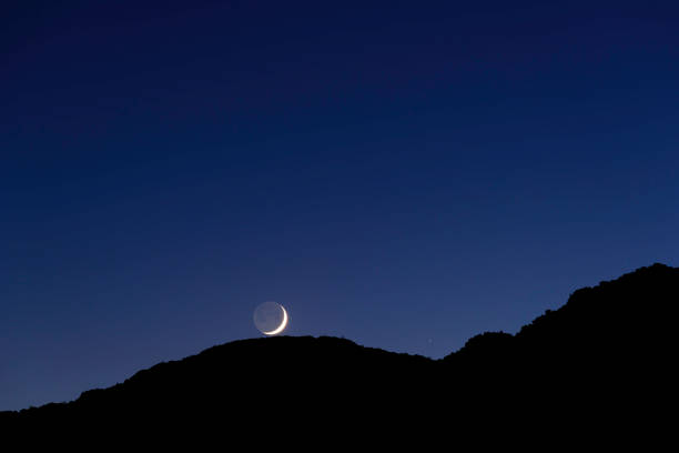 istock Crescent Moon on top of mountain peak 688599316