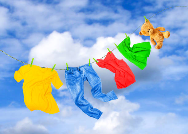 Laundry line with colored clothes, against the background of a cloudy sky