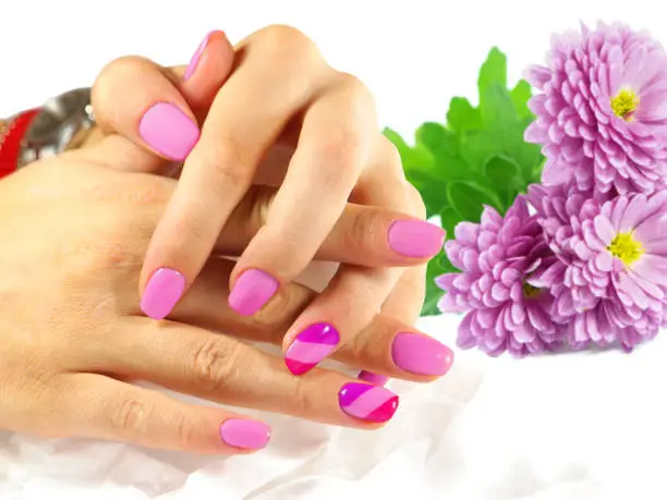 Nail art. Nail designs. Beautiful manicure with purple flowers on background