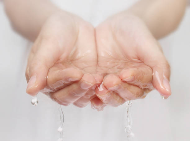 istock woman hand and water 688604180
