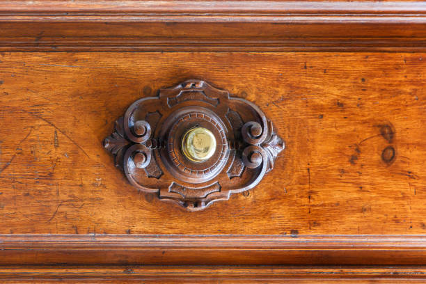 An old bell button on a wooden door