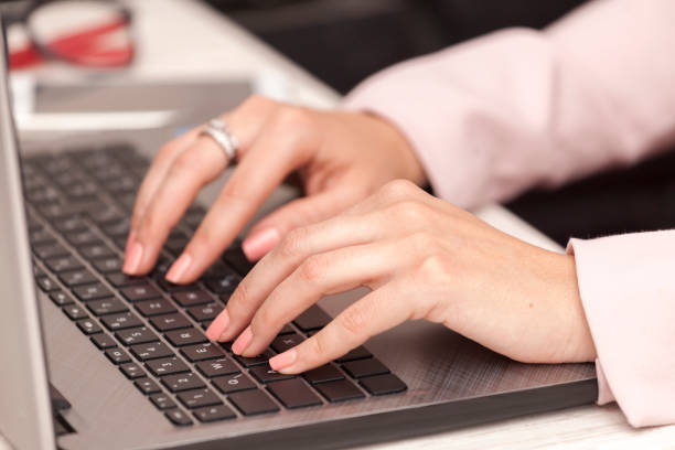 istock Close-up of typing female hands on keyboard 688609716
