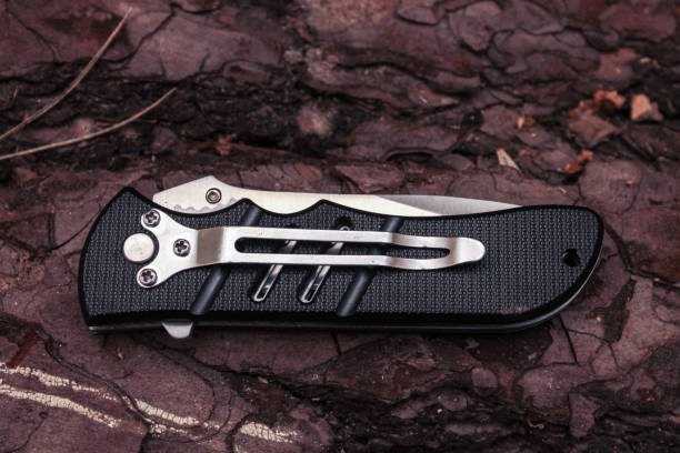 istock Pocket knife with a clip on the pine bark. 688661180