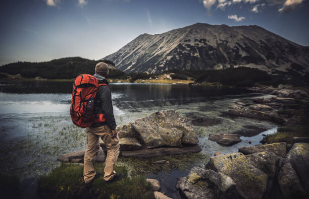 istock Traveler watching the sunset over the mountains 688725412