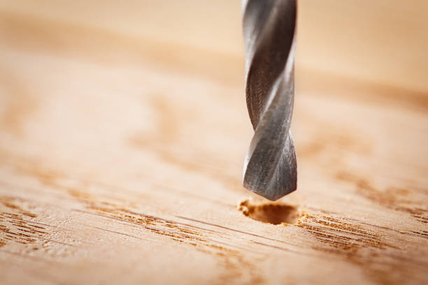istock metal drill bit make holes in wooden oaks plank 688727720