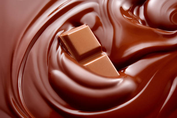 istock Melted hot liquid chocolate with chocolate pieces. Chocolate background. 688730092