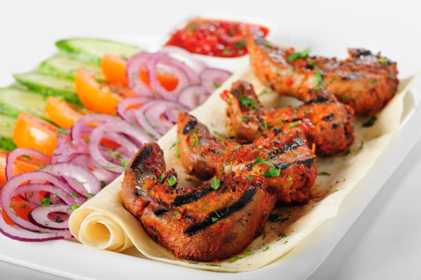 istock Grilled lamb tongues with fresh vegetables salad 688730532