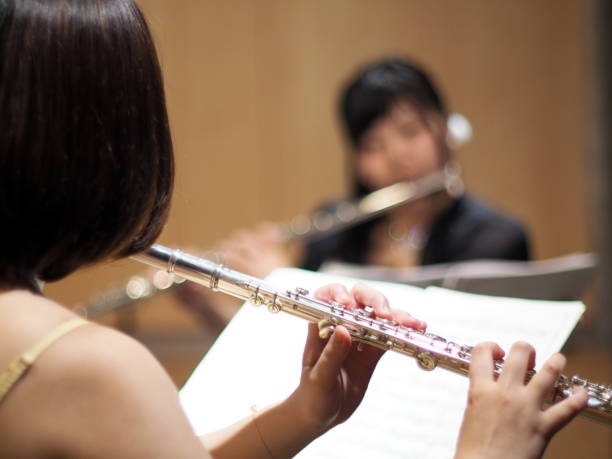 istock Close Up of a Woman Playing a Flute 688731018