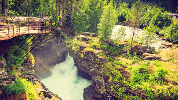 istock Tourist with camera on Gudbrandsjuvet waterfall, Norway 688739040