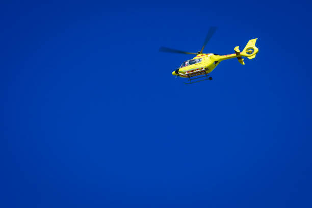 istock Yellow helicopter on clear dark blue sky 688741916