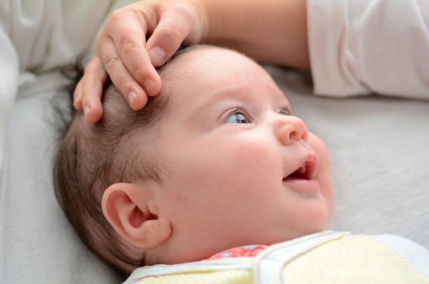 istock Sister touches her newborn sister 688745920