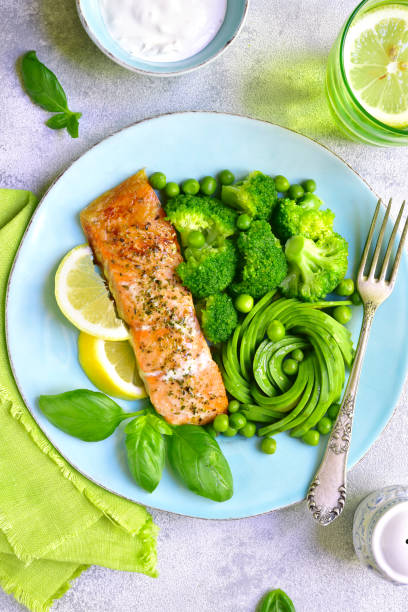 istock Grilled salmon garnished with green vegetables 688754228