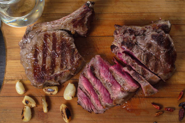 istock Grill meat rib eye steak composition on wooden background 688764760