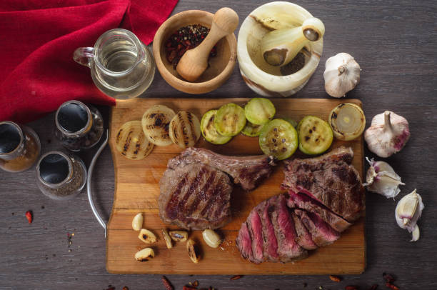 istock Grill meat rib eye steak composition on wooden background 688764856