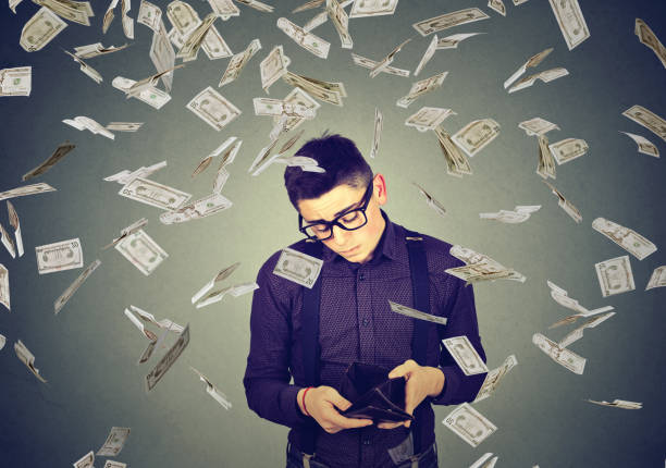 istock sad man looking at his empty wallet under money dollar banknotes rain 688771462